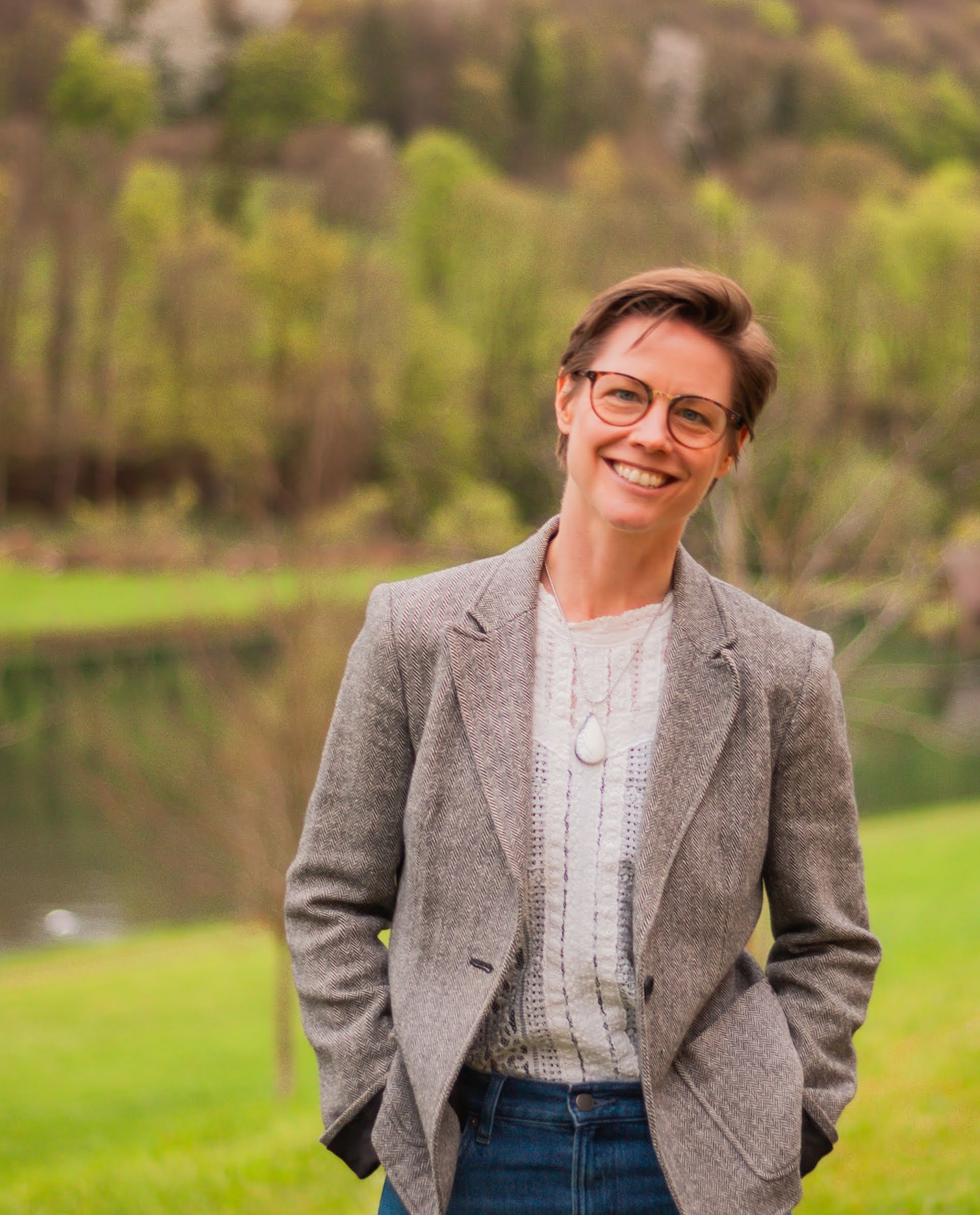 Nicole standing on a lawn wearing a jacket